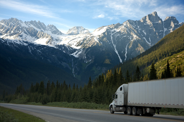 Truck on road, mountains in background